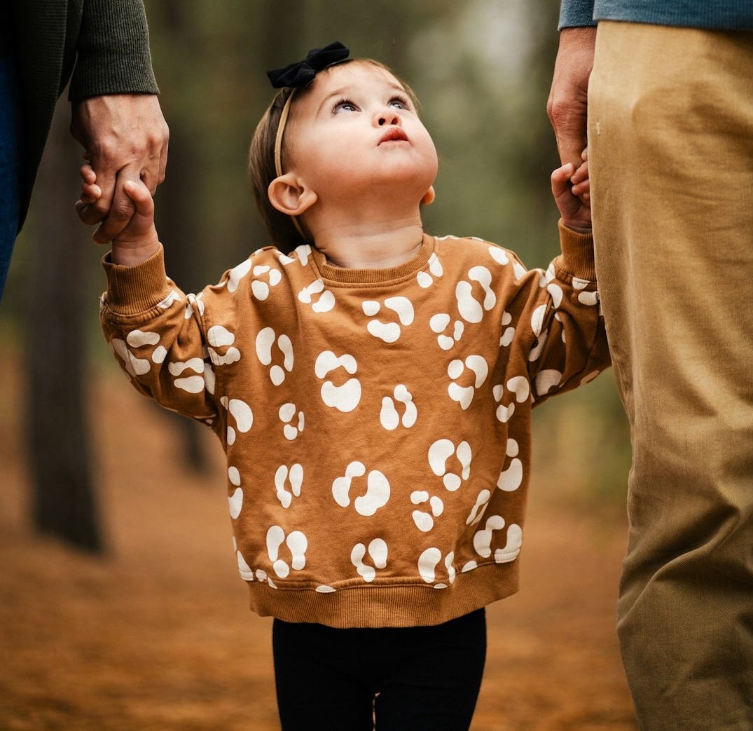 a little girl holding the hand of a man a little girl holding the hand of a man
