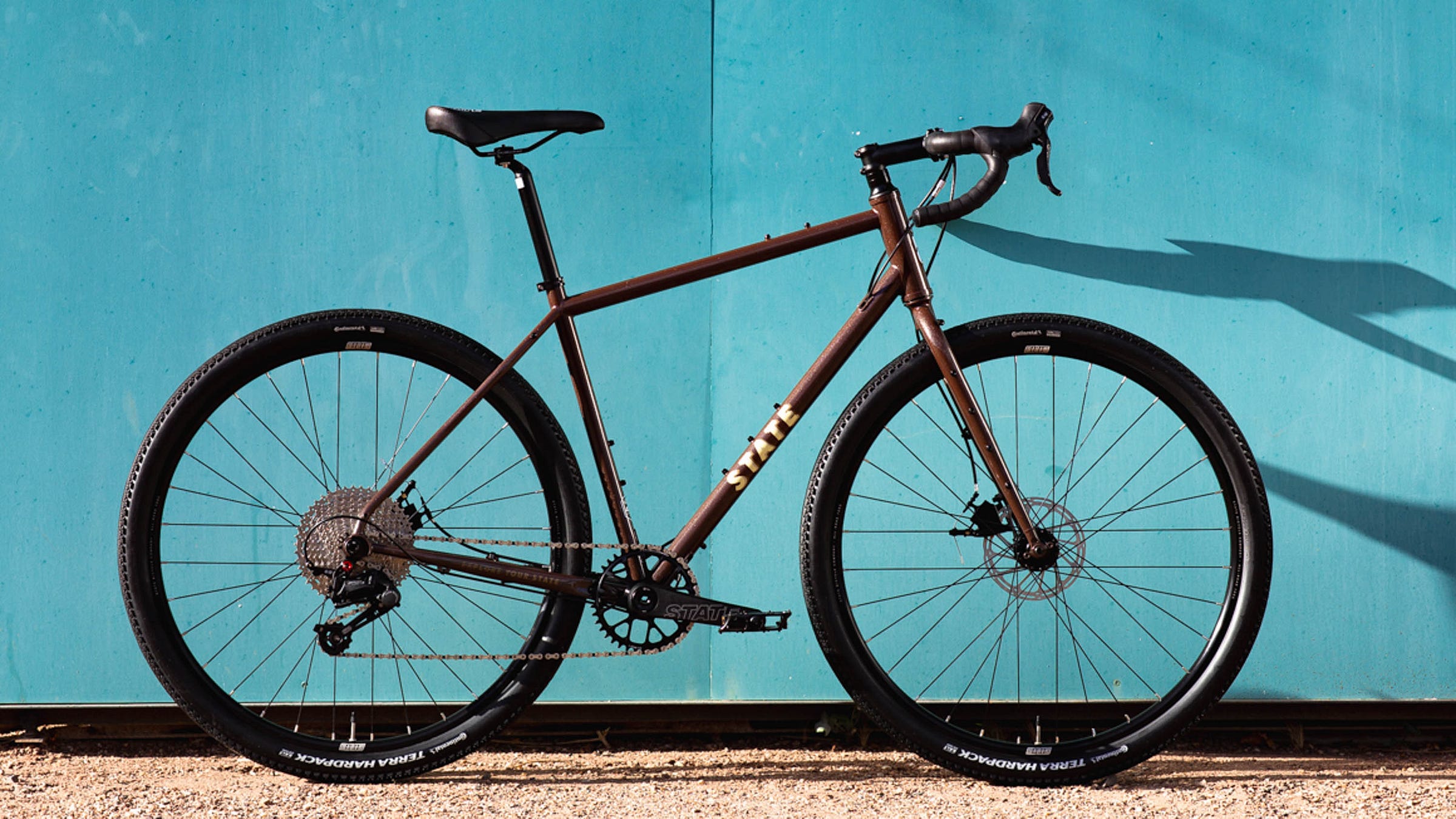 State Bicycle Company 4130 All-Road against blue wall