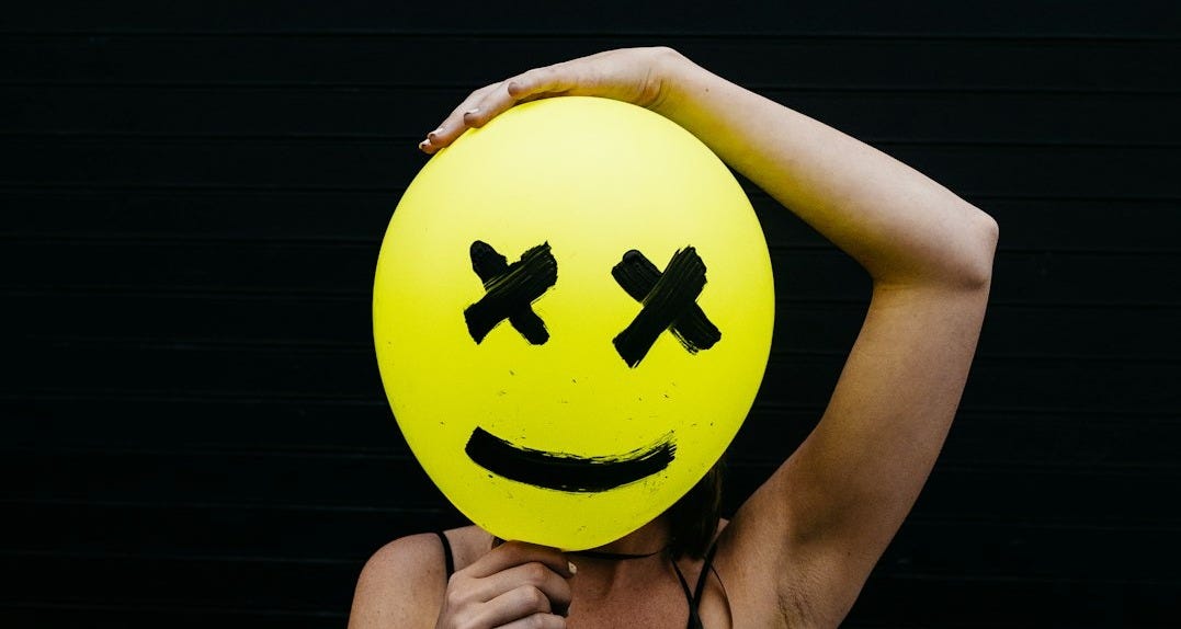 woman holding yellow and black balloon at daytime woman holding yellow and black balloon at daytime