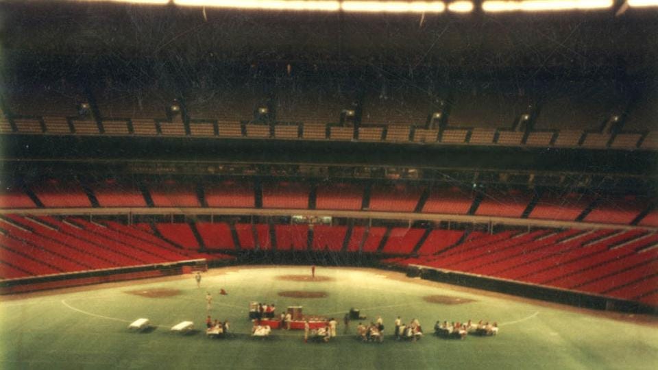 Wide shot of the picnic dinner in the deserted Astrodome.