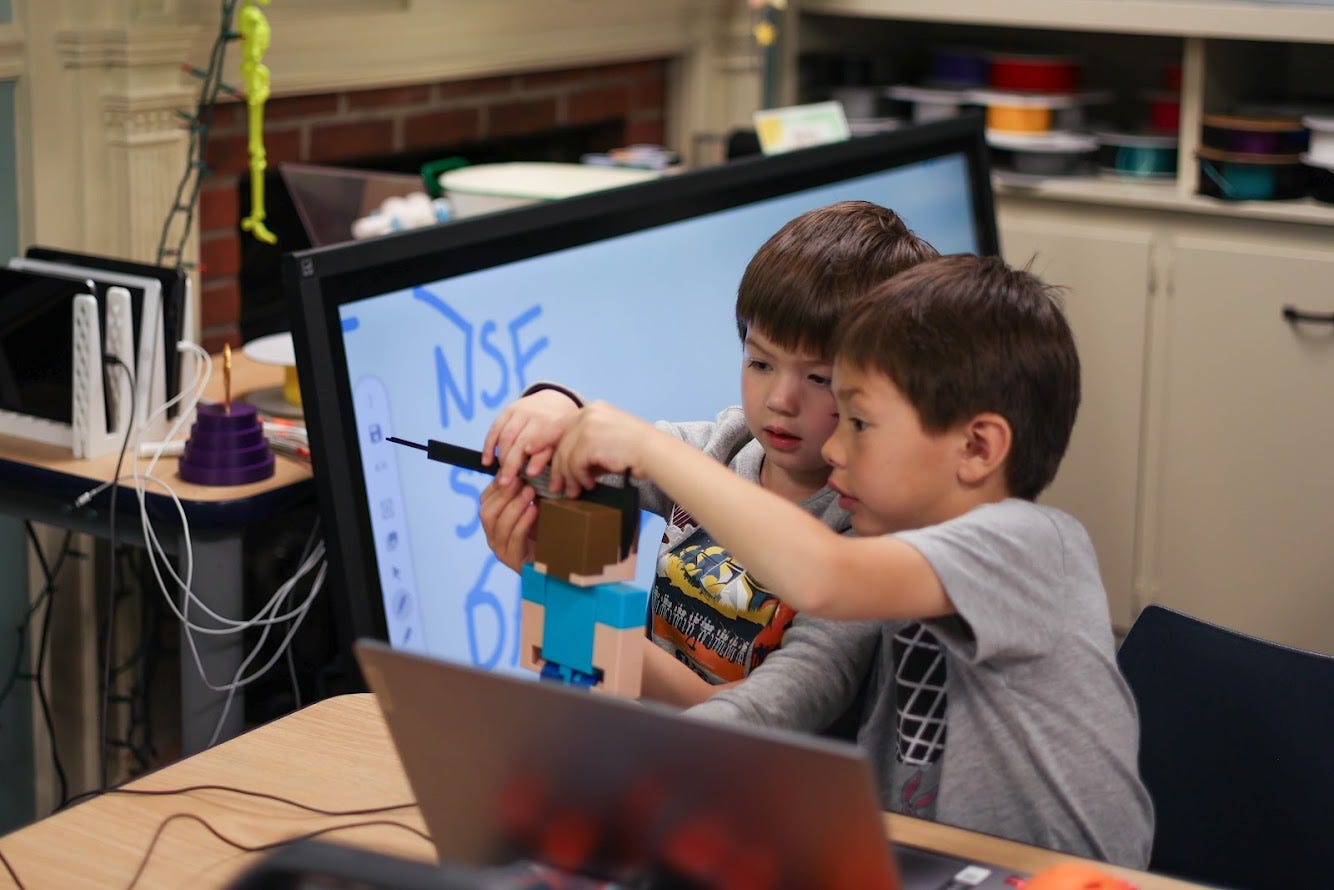Two kid measure toy Steve Minecraft head with a caliper.