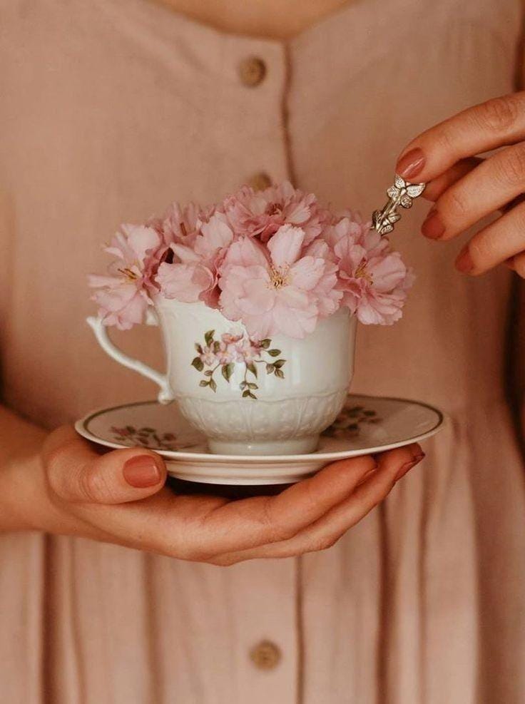 May be an image of coffee cup and flower May be an image of coffee cup and flower