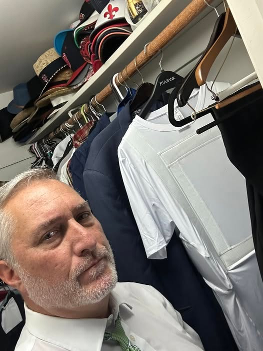 May be an image of 1 person, suit and hat shop