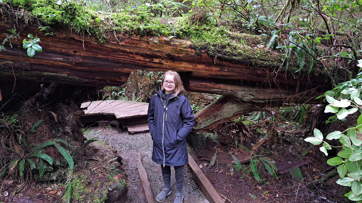 Me, a young woman, posing in a forest in the pacific northwest