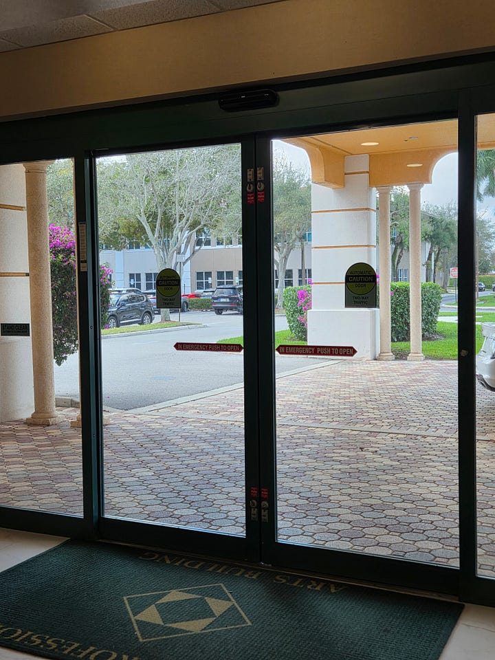 Clockwise from top left: A set of automatic, sliding doors; a set of heavy glass doors with a vertical handle the height of the door; an image of a square button with a wheelchair symbol on it that says “Press to Open”; and a set of heavy glass doors and a steel frame (painted white), with small metal handles on each.