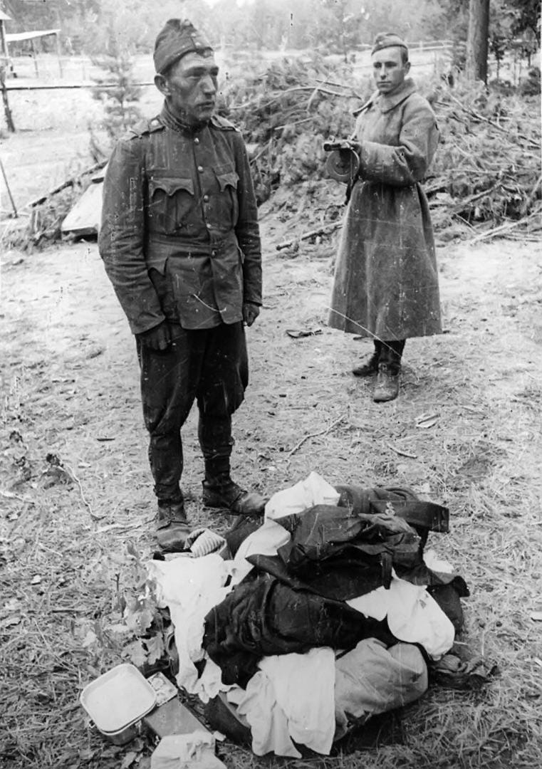 Photo of a Soviet soldier holding a Hungarian soldier at gunpoint after finding looted property in his luggage, 1942