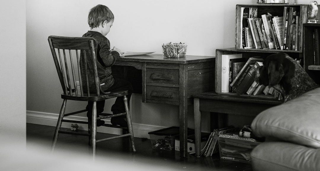man and woman sitting on chair in front of table