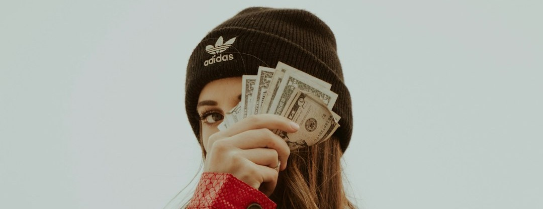 woman in black knit cap covering her face with her hand woman in black knit cap covering her face with her hand