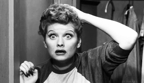 Lucille Ball looks in the mirror.