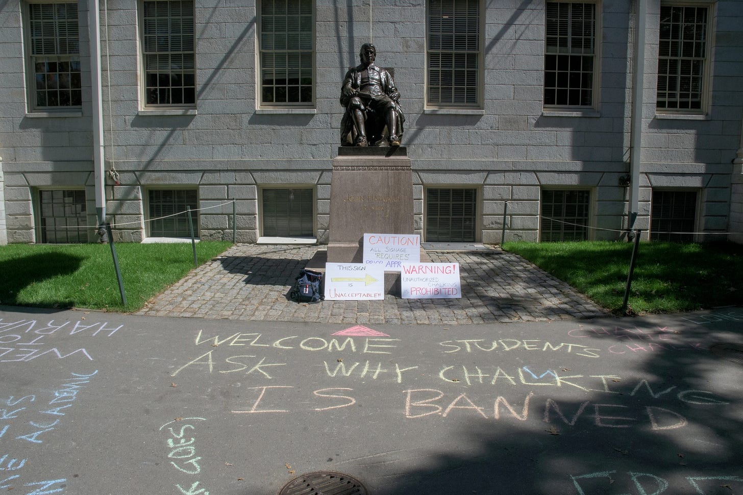 Five Harvard professors wrote messages in chalk in Harvard Yard Tuesday in protst of the University's restrictions on the use of campus spaces. Five Harvard professors wrote messages in chalk in Harvard Yard Tuesday in protst of the University's restrictions on the use of campus spaces.