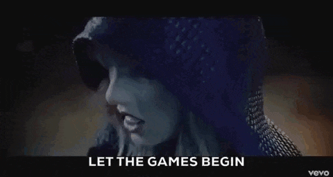 taylor swift is wearing a blue sweater and a hooded jacket in the video for her song let the games begin .