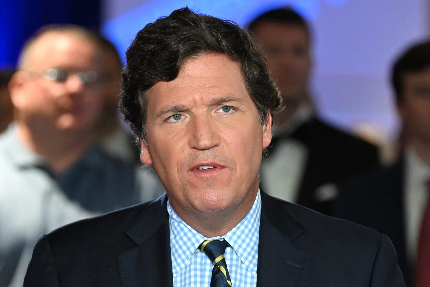 Tucker Carlson's big stupid face.