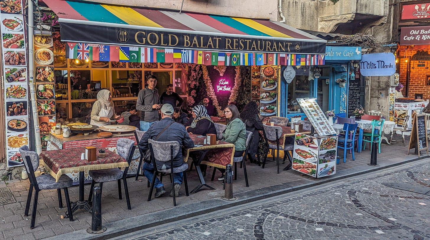 People eating outdoors at the Gold Balat restaurant. 