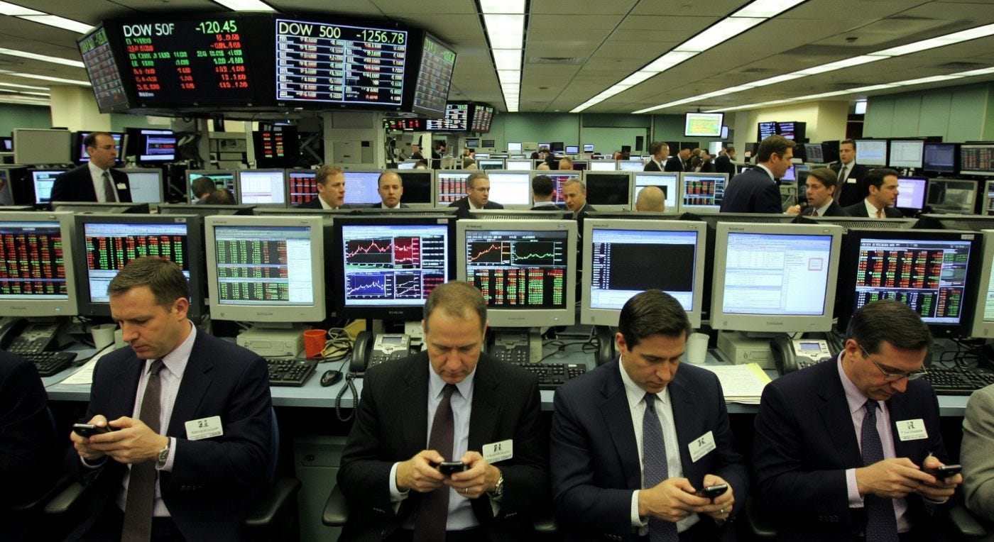 Stock traders in business suits using phones at financial trading floor with market displays Stock traders in business suits using phones at financial trading floor with market displays