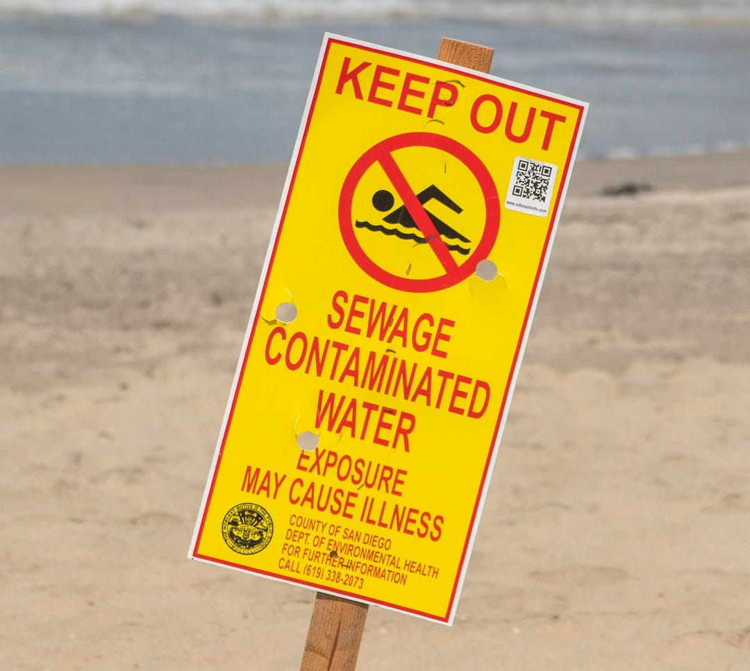 a yellow sign on a beach a yellow sign on a beach