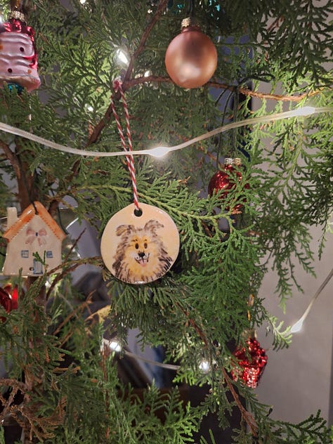 Ornaments on the tree, one comparing the portrait next to the actual dog