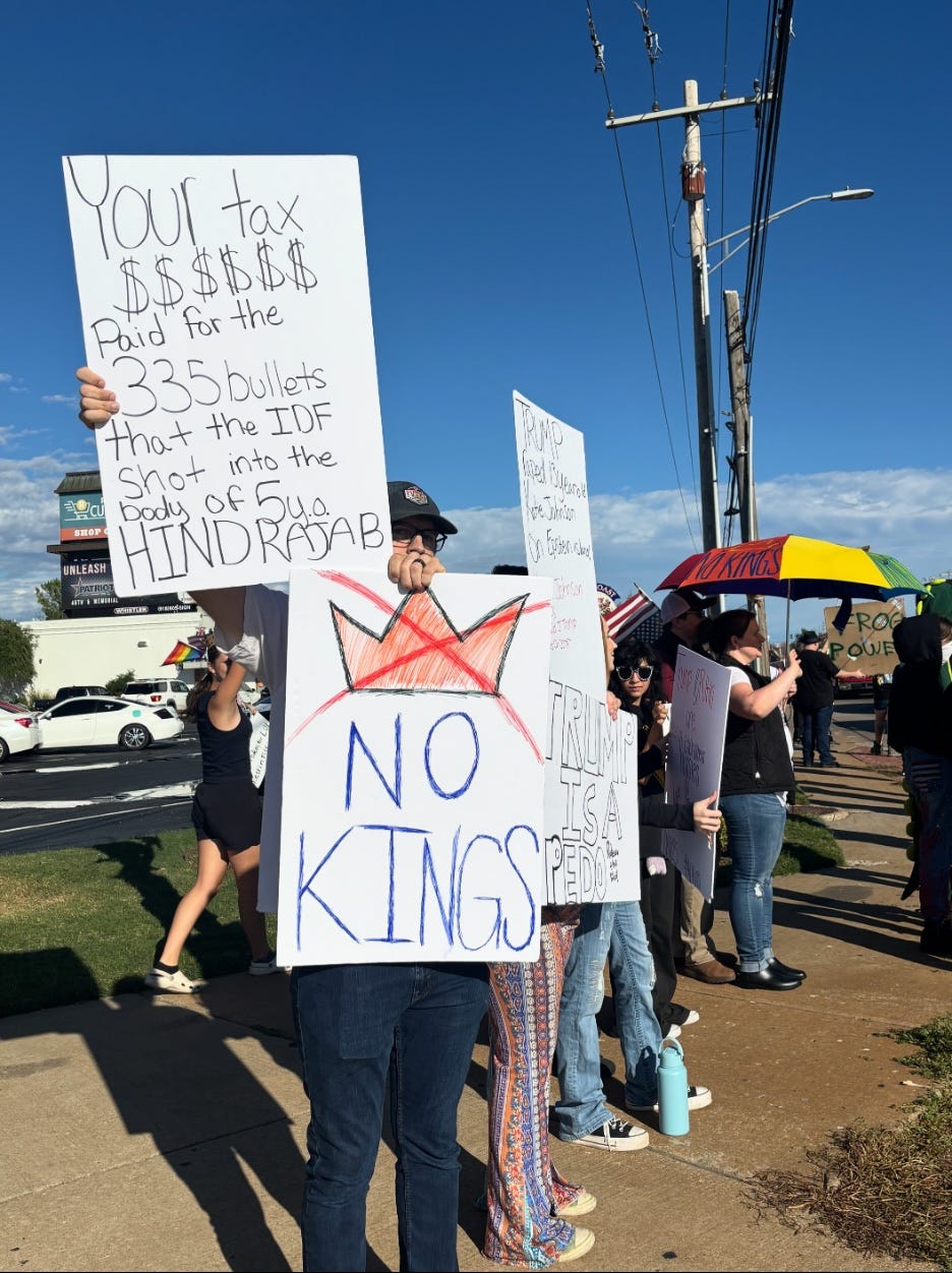 A group of people holding signs

AI-generated content may be incorrect.