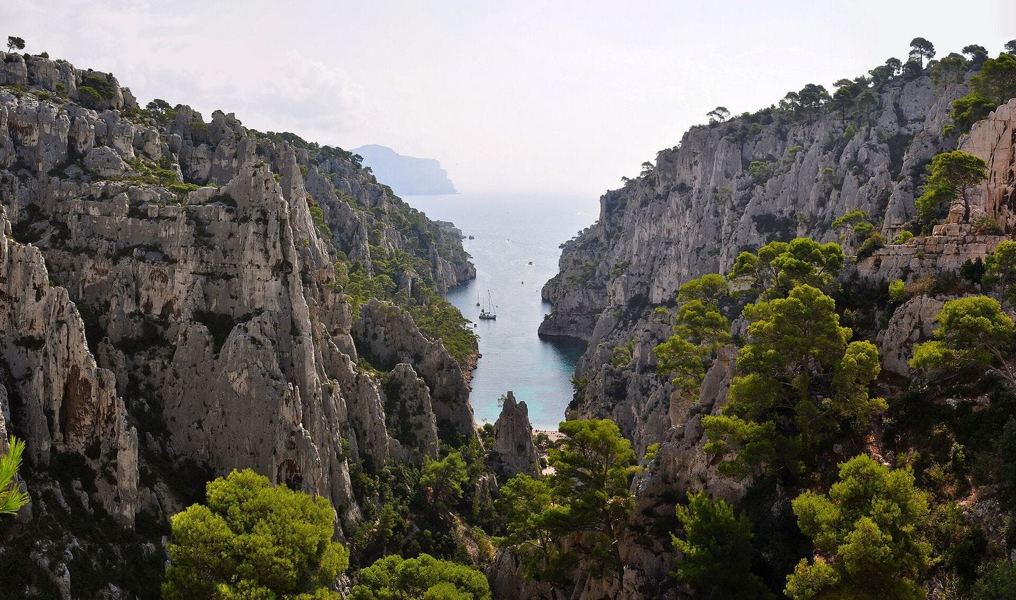 The limestone walls of Calanque d'En-Vau dropping to the Mediterranean The limestone walls of Calanque d'En-Vau dropping to the Mediterranean