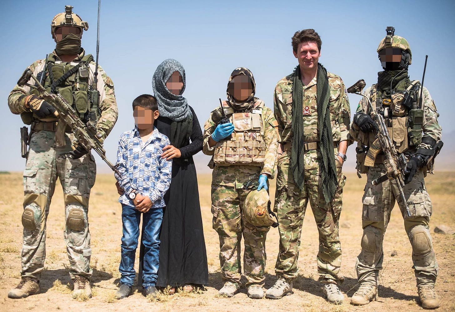 <p>Major General Charlie Herbert (second right) with a female member of the Triples unit </p>