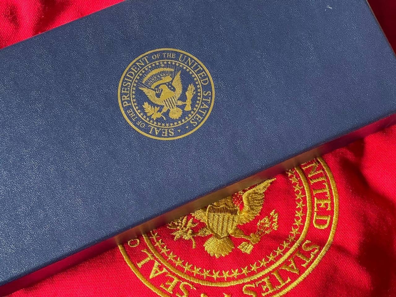 The cobalt blue outer box, bearing the Seal of the President The cobalt blue outer box, bearing the Seal of the President