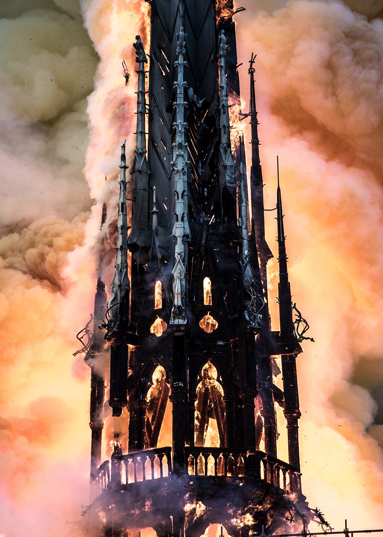 Close view of the spire of Notre-Dame engulfed in flames and smoke