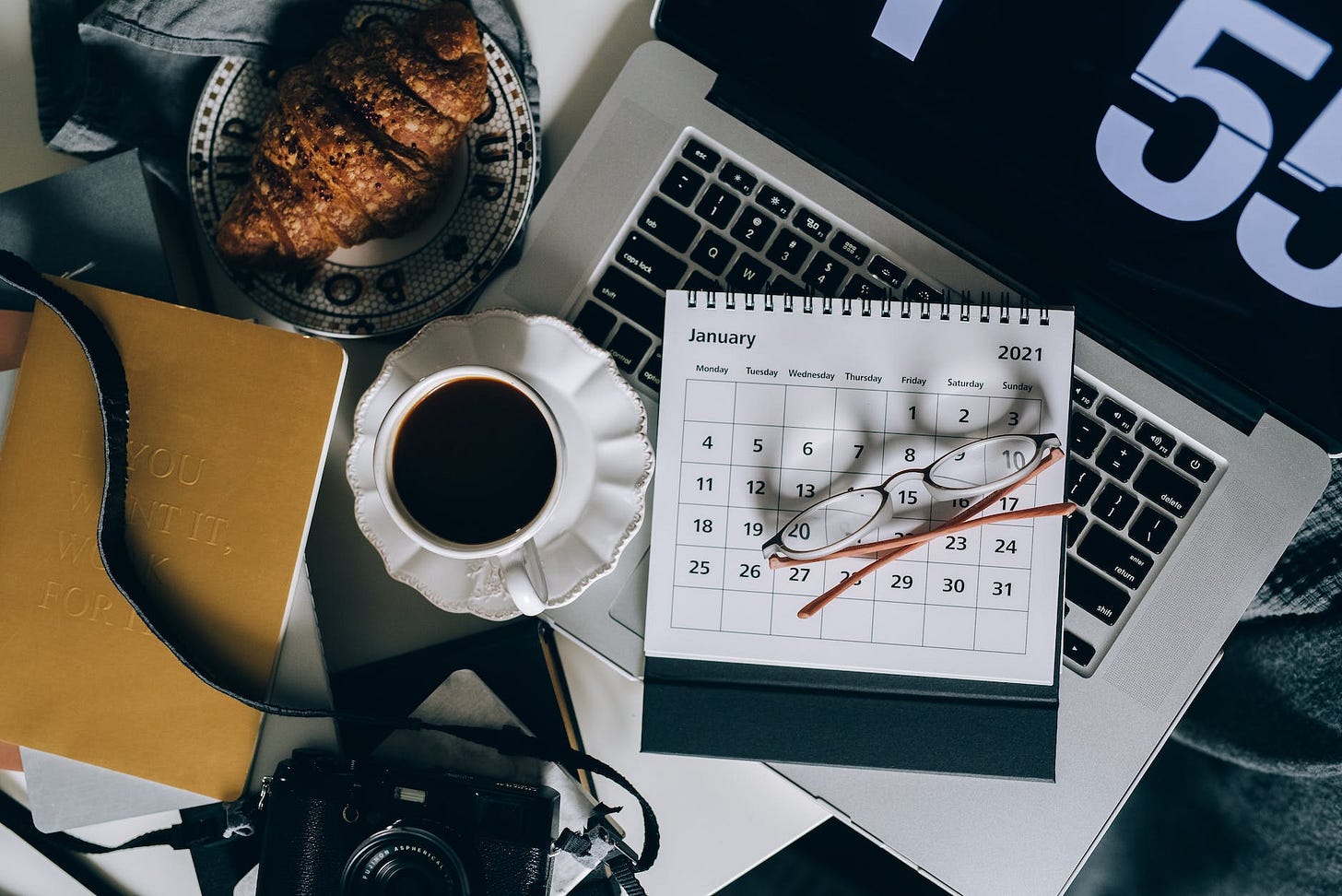 calendar on a laptop beside a cup of black coffee calendar on a laptop beside a cup of black coffee