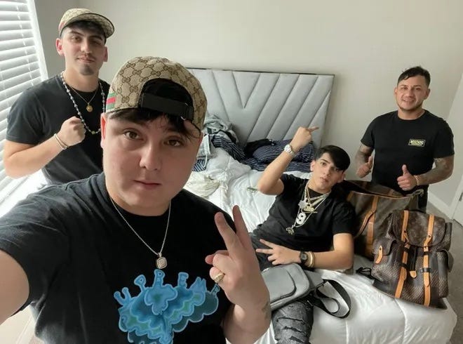 Illegal immigrants pose with luxury loot stolen from NFL players home.