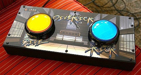 Huge video game controller with two big buttons: the left one is yellow and labeled “dive,” the right one is blue and labeled “kick.” Huge video game controller with two big buttons: the left one is yellow and labeled “dive,” the right one is blue and labeled “kick.”