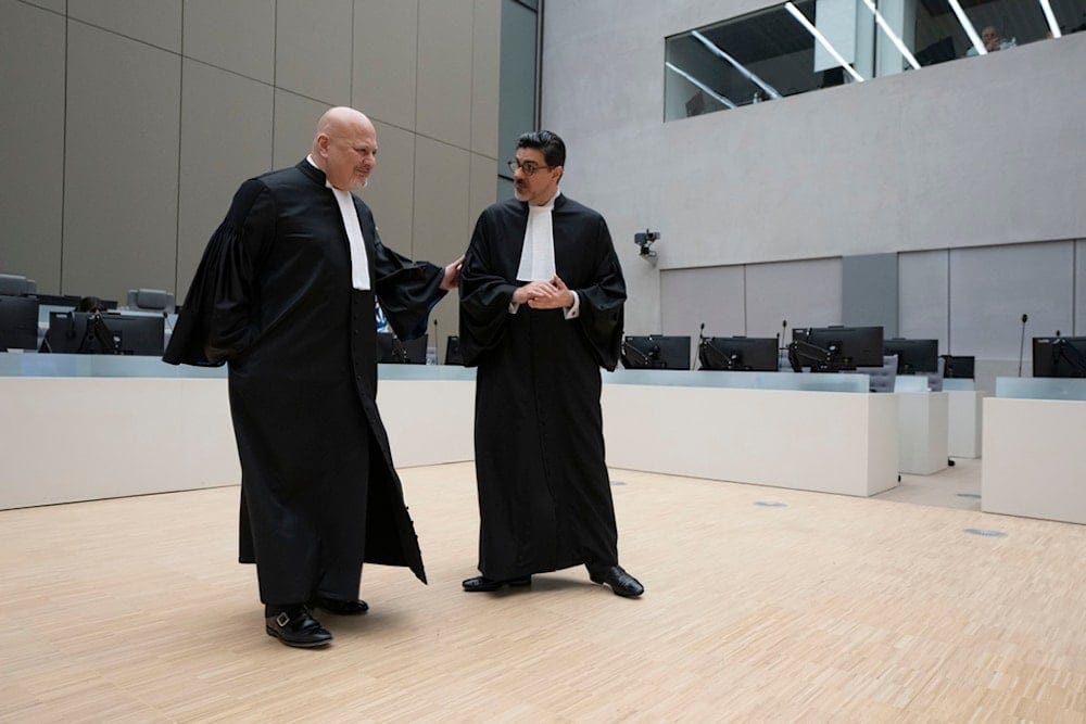 Chief Prosecutor Karim Khan, left, talks to registrar Osvaldo Zavala Giler at the International Criminal Court (ICC) in The Hague, Netherlands, Friday, March 14, 2025 (AP) Chief Prosecutor Karim Khan, left, talks to registrar Osvaldo Zavala Giler at the International Criminal Court (ICC) in The Hague, Netherlands, Friday, March 14, 2025 (AP)