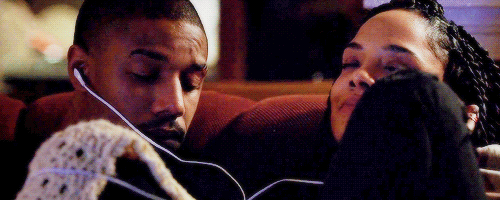 This may contain: two people sitting next to each other with headphones on