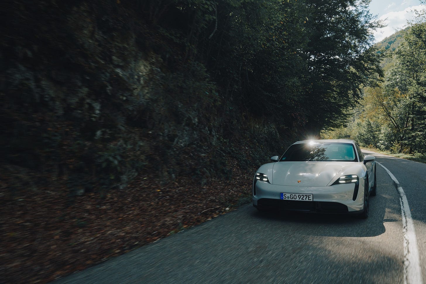 May be an image of car, road and text