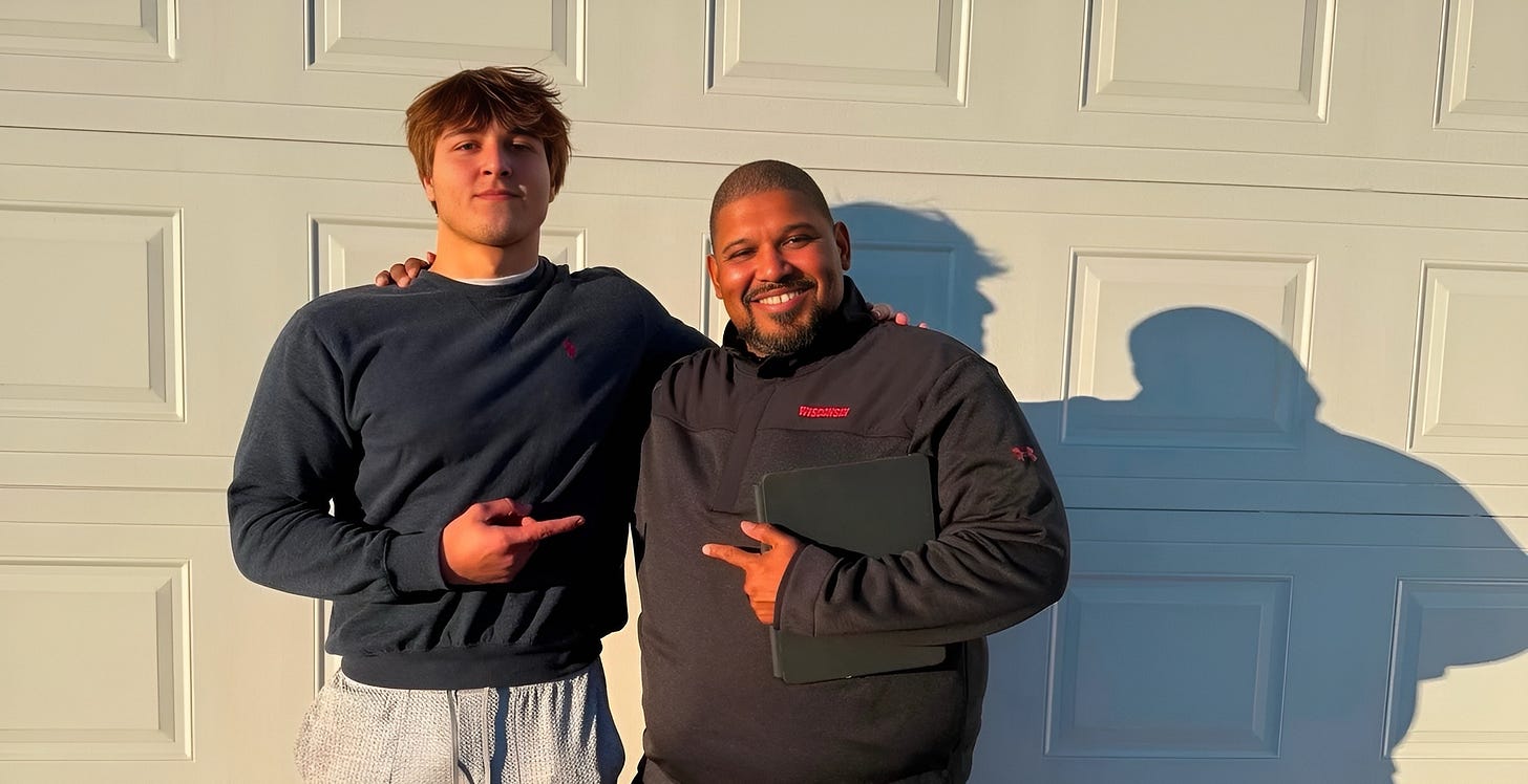 Yahya Gaad stands next to Wisconsin defensive line coach E.J. Whitlow during an in-home recruiting visit. Yahya Gaad stands next to Wisconsin defensive line coach E.J. Whitlow during an in-home recruiting visit.