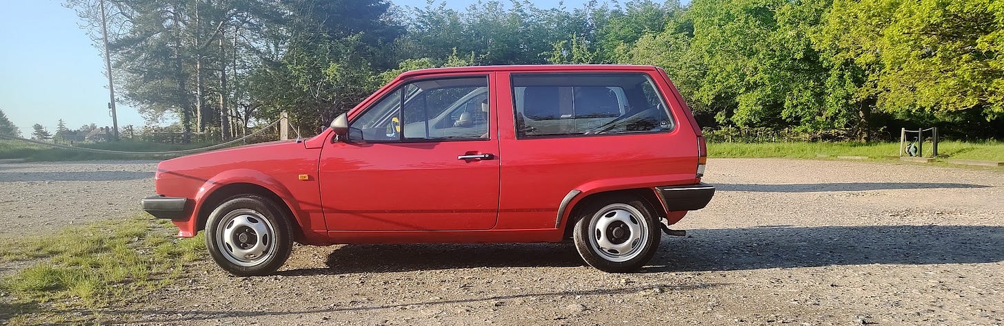 Red MK2 Polo against the backdrop of a country park