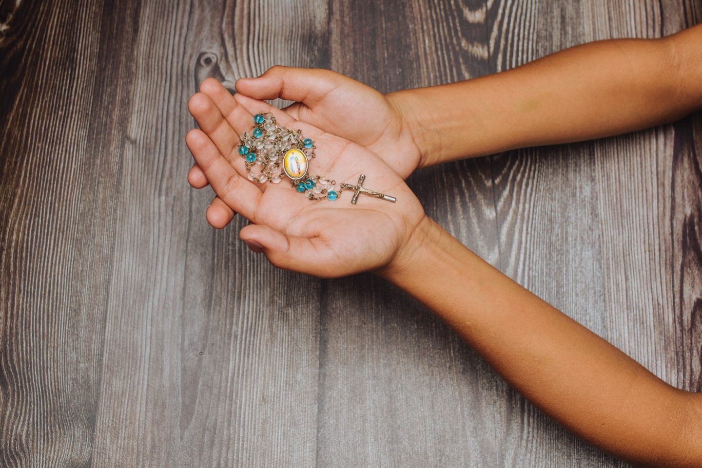 Hands holding rosary