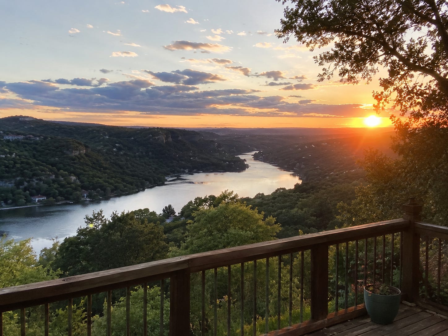 View from a deck overlooking Lake Austin and the Texas Hill Country at sunset, with rolling hills and a distant horizon reflecting the essay's themes of ambition, purpose, and living in the present. View from a deck overlooking Lake Austin and the Texas Hill Country at sunset, with rolling hills and a distant horizon reflecting the essay's themes of ambition, purpose, and living in the present.