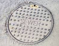 A manhole cover in the ground

AI-generated content may be incorrect.