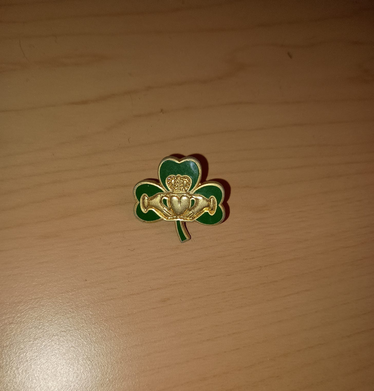green clover with a gold claddagh irish heart