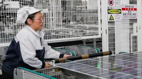 Getty Images An employee working on the production line of solar panels at a workshop of Trina Solar in China.
