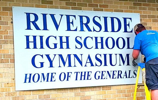 A district employee changes the school sign at Riverside High School, formerly Robert E. Lee High School. August 2, 2021. Accessed via Resident News. A district employee changes the school sign at Riverside High School, formerly Robert E. Lee High School. August 2, 2021. Accessed via Resident News.