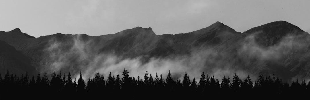 a black and white photo of a mountain range
