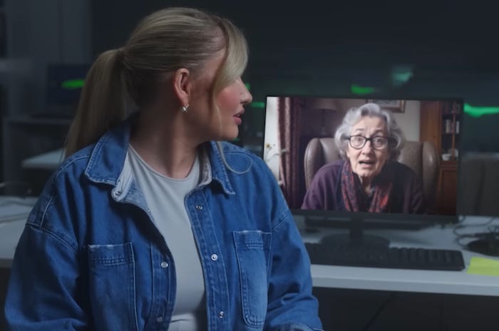 screenshot from AI Scambaiters: O2 creates AI Granny to waste scammers’ time of woman looking over her shoulder at an AI elderly lady on a computer screen