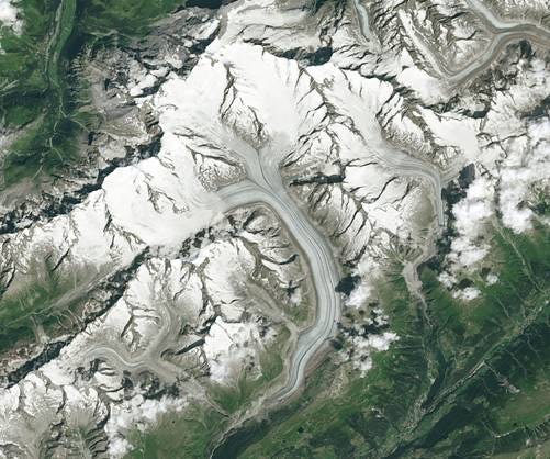 Aerial view of a snowy mountain

AI-generated content may be incorrect.