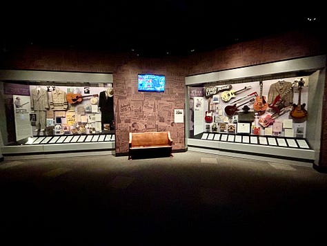 exhibits, display, guitars, case, signs