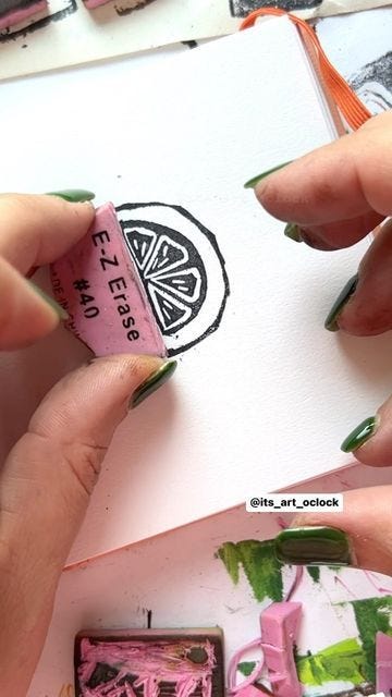 This may contain: two hands are painting on paper with pink and green paint, while another hand is holding a stamp