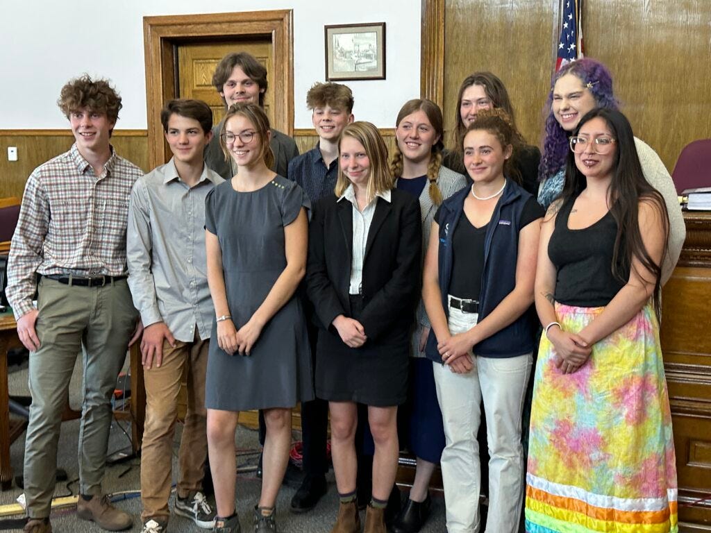 Eleven of the 16 youth plaintiffs in the Held v. Montana case pose for a photo after Day 5 of the trial on Friday, June 16, 2023. Top row (right to left): Lander Busse, Badge Busse, Grace, Rikki Held, Olivia. Bottom row (right to left): Kian, Mica, Claire, Eva, Taleah, Sariel. Eleven of the 16 youth plaintiffs in the Held v. Montana case pose for a photo after Day 5 of the trial on Friday, June 16, 2023. Top row (right to left): Lander Busse, Badge Busse, Grace, Rikki Held, Olivia. Bottom row (right to left): Kian, Mica, Claire, Eva, Taleah, Sariel.