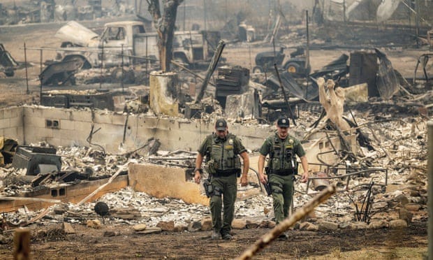 Sheriff's deputies leave a home where a McKinney fire victim was found on Monday, in Klamath National Forest, California. Sheriff's deputies leave a home where a McKinney fire victim was found on Monday, in Klamath National Forest, California.