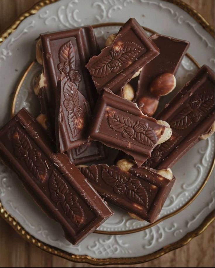 This may contain: chocolate bars on a plate with nuts