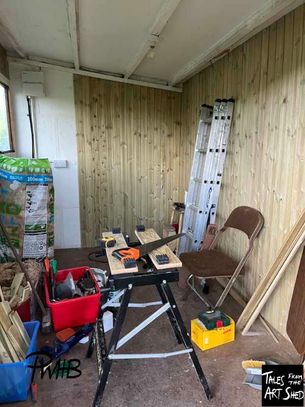 Work in progress of cladding on inside of shed and tools strewn around