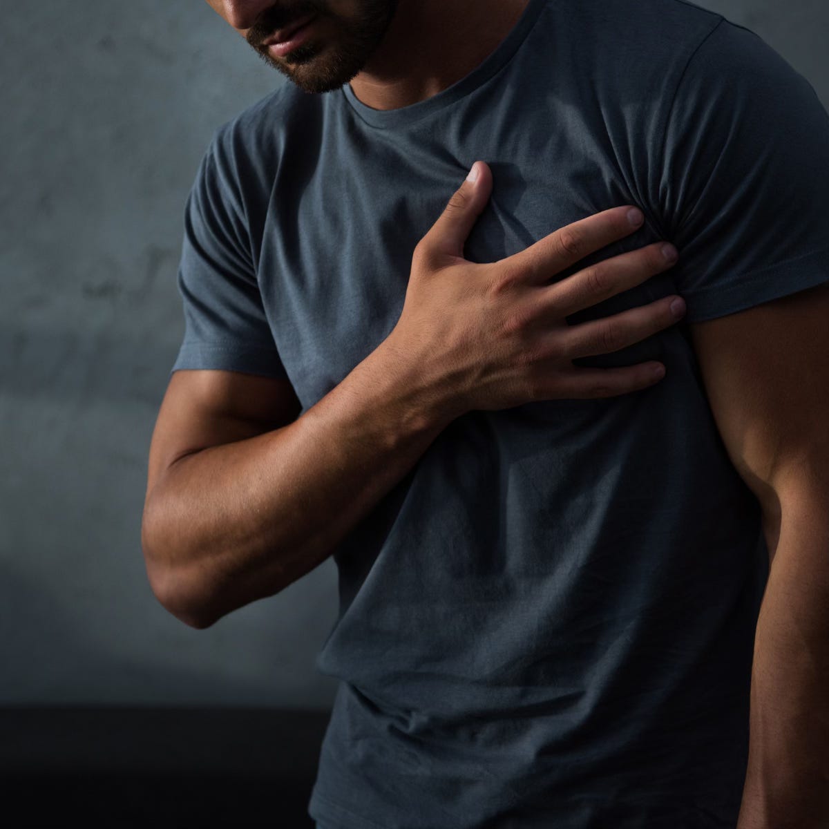 Man with hand on his chest