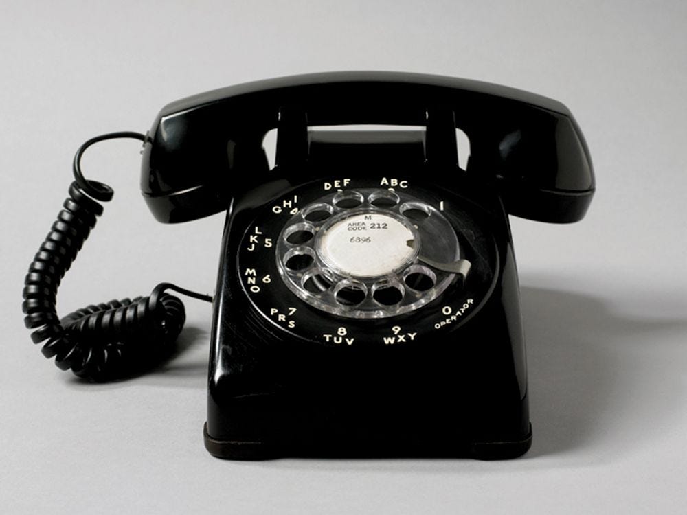 Image may contain Electronics Phone Camera and Dial Telephone